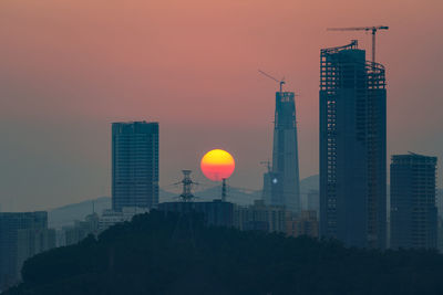 Low angle view of buildings against sky during sunset