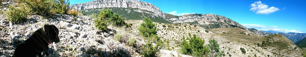 Low angle view of mountain against blue sky