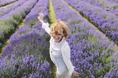 Cheerful of woman dancing on lavender field