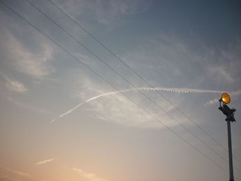 Low angle view of street lights against sky