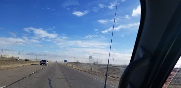 Cars on road against sky