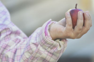 Close-up of woman holding pink hand