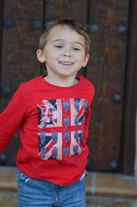 Portrait of smiling boy standing outdoors