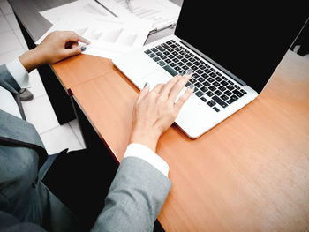 High angle view of woman using laptop on table