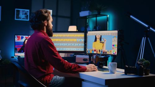 Rear view of woman using mobile phone in cafe