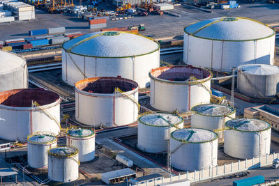 White oil storage tanks seen in the commercial port of barcelona