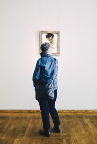 Rear view of man standing at home