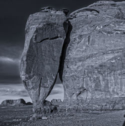 Close-up of rock on landscape against sky