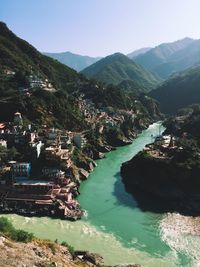 High angle view of townscape by mountain against sky