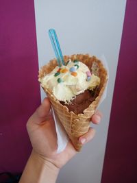 Close-up of hand holding ice cream cone