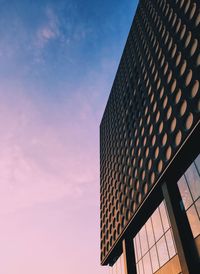 Low angle view of building against sky during sunset