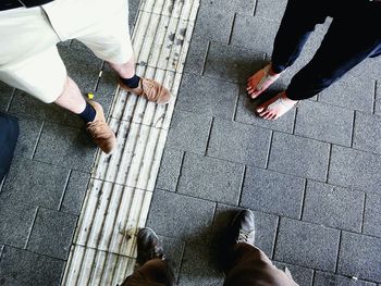 Low section of person standing on tiled floor