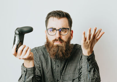 Portrait of young man with hands against white background