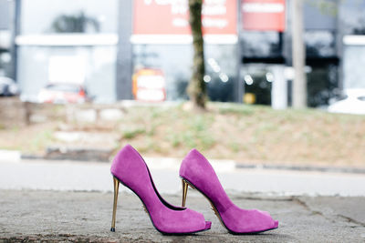 Close-up of pink shoes on street