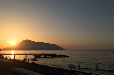 Scenic view of sea against clear sky during sunset