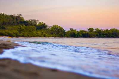 Scenic view of river against sky during sunset
