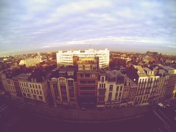 Cityscape against cloudy sky