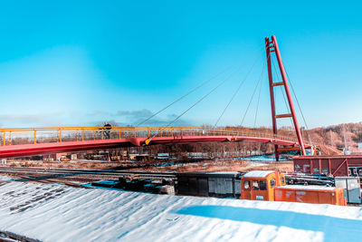 View of suspension bridge against blue sky