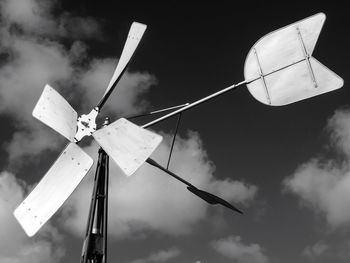 Close-up of windmill against sky