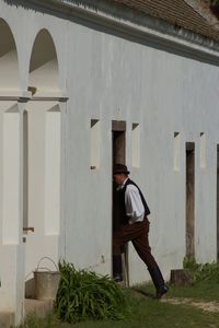 Side view of man entering building