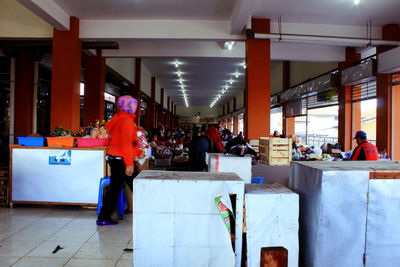 Group of people walking in corridor of building