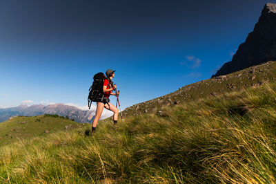 Rear view of man standing on mountain