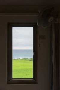 Scenic view of sea seen through window
