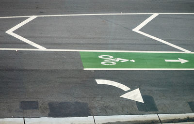 High angle view of arrow sign on road