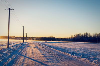 Scenic view of field against clear sky during sunset