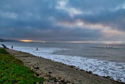 Scenic view of beach against sky during sunset