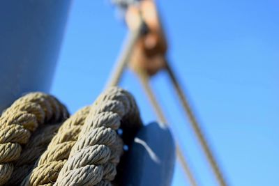 Low angle view of rope against blue sky