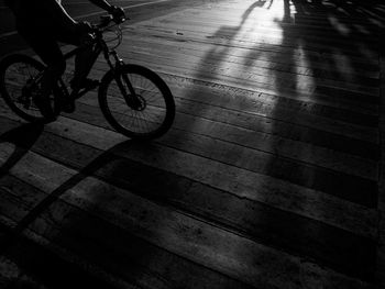 Low section of man riding bicycle on floor