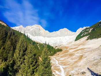 Scenic view of mountains against blue sky