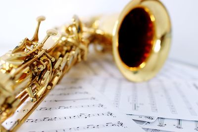 Close-up of saxophone on sheet paper
