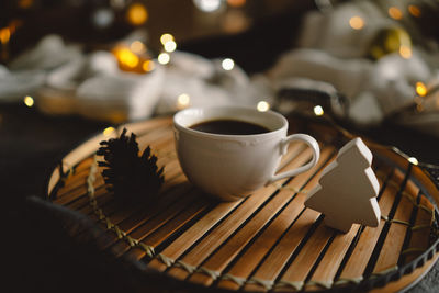 Christmas cup of coffee with sweater and christmas decorations.