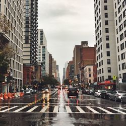 Cars on wet road in city during rainy season