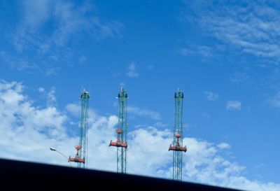 Low angle view of communications tower against blue sky