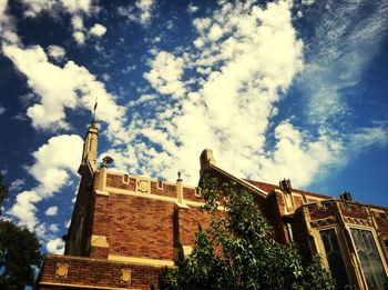 Low angle view of building against cloudy sky