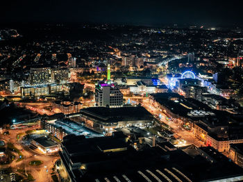 High angle view of illuminated buildings in city at night