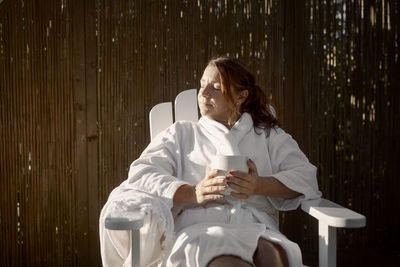 Woman having coffee in garden