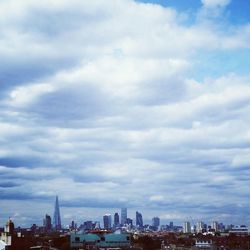 Skyscrapers against cloudy sky