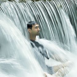 Portrait of young man in water