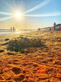 People on beach against sky