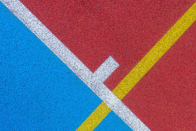 Colorful sports court background. top view to red and blue field rubber ground with  lines outdoors.