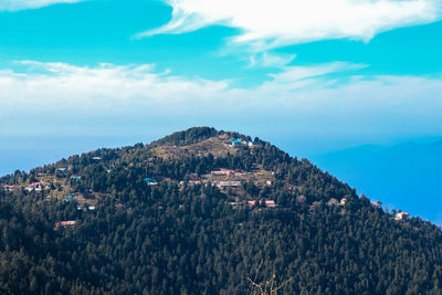 Scenic view of mountains and buildings against sky