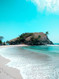 Scenic view of beach against clear blue sky