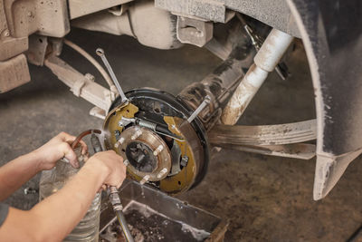 Cropped hand of man repairing car