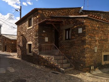 Old building in town against sky