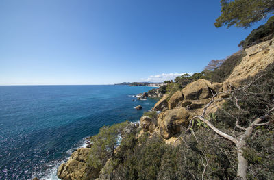 Scenic view of sea against clear blue sky