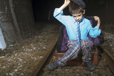 Full length of girl sitting in corridor